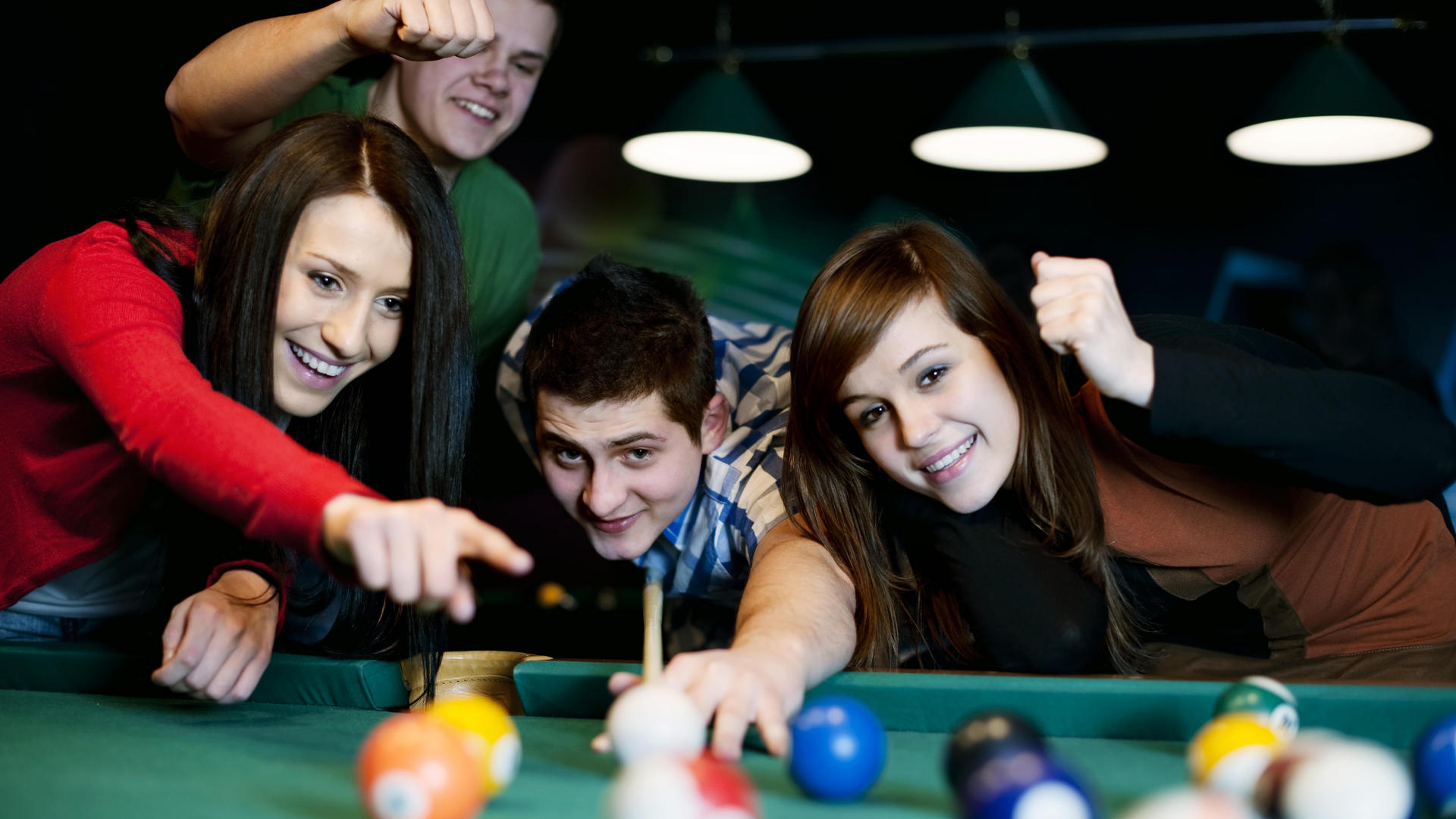 group of friends at pool table
