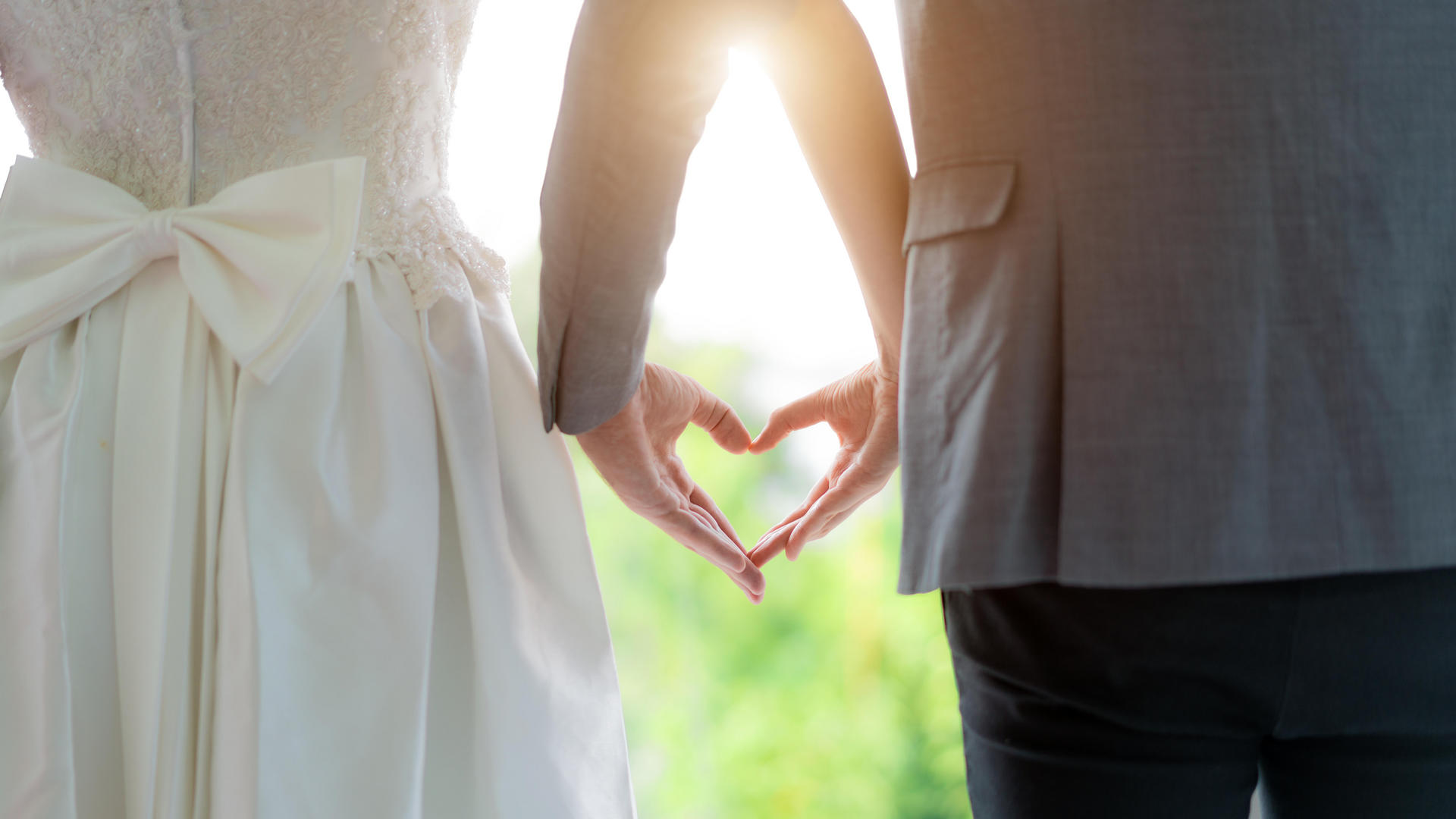 wedding couple holding hands in shape of a heart