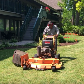 Abbey employee mowing the lawn