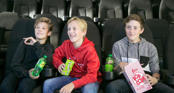 boys watching movie in immersion cinema