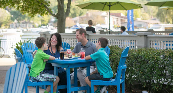 family dining at waterfront patio