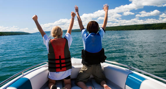 kids in boat on lake