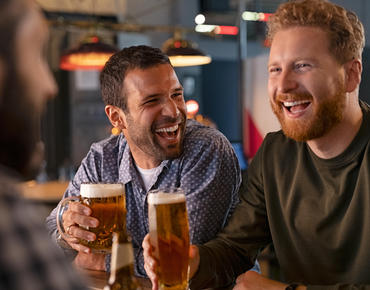 men drinking beer and laughing