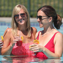ladies with drinks in pool