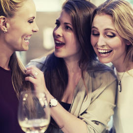 ladies laughing over wine