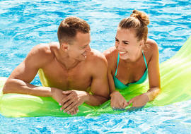 couple on float in outdoor pool