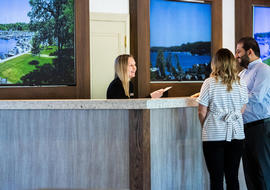 front desk employee checking couple in to resort